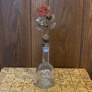 Glass bottle with iron antique flowers